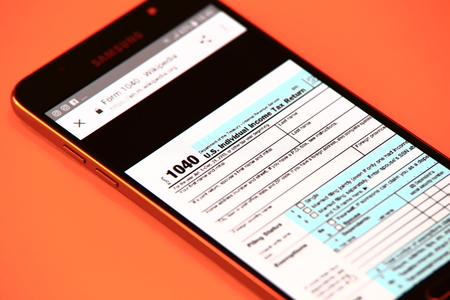 New York, USA - October 29, 2017: Tax form on smartphone. Online tax form.のeditorial素材