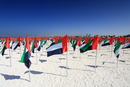 Flags of United Arab Emirates on beach. National holiday UAE flag day.の写真素材