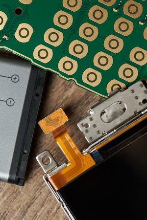 Main parts of mobile phone close up. Battery, board and screen of smartphoneの写真素材
