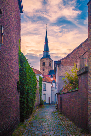 Narrow Brugge street. Classic Bruges city view. Sunset in Brugge.の写真素材