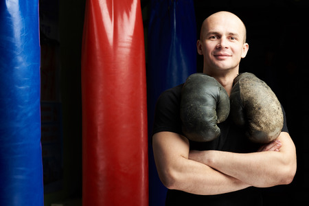 One boxing man with crossed arms on punch bag backgroundの写真素材