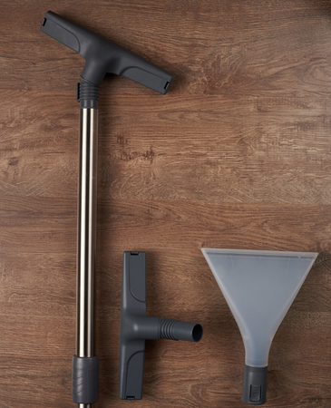 Set of tool for cleaning floor on wooden background above top viewの写真素材