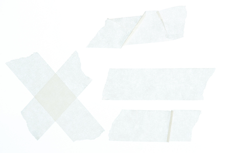 Set of white wrinkled masking tape pieces close up isolatedの写真素材