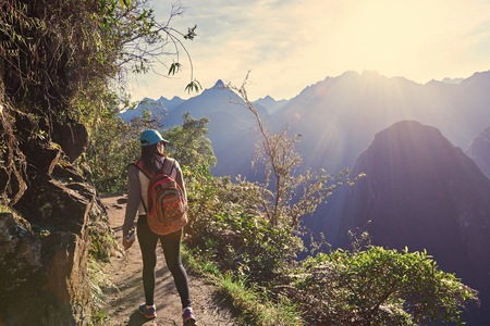 Young girl hike in beautiful landscape on sunny light dayの写真素材