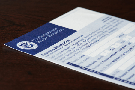 New york, USA - April 9, 2018: Customs declaration form laying on wooden table close-upのeditorial素材