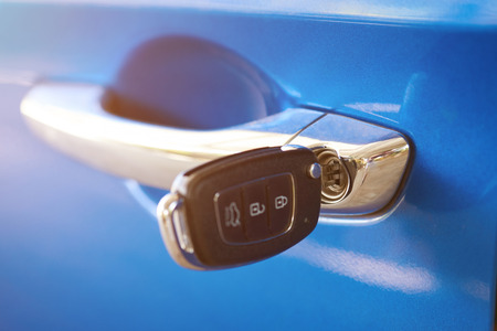 Unlocking car theme. Car key in door handle close upの写真素材