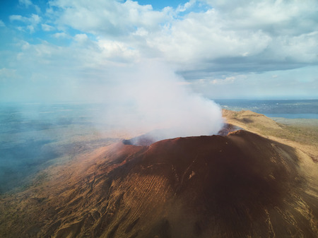 Active vacation theme. Hiking on active volcano craterの写真素材