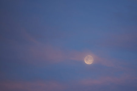 Purple sunset sky with full moon. Misty skyscape
