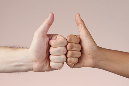 Two hand show thumb up isolated on brown backgroundの写真素材