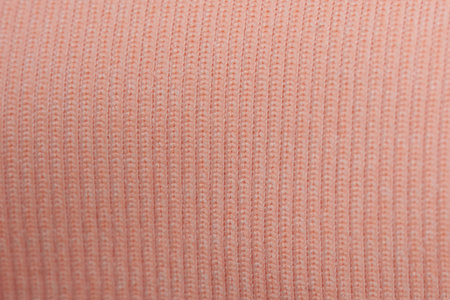 Pink fabric texture close up view. Fiber surface background