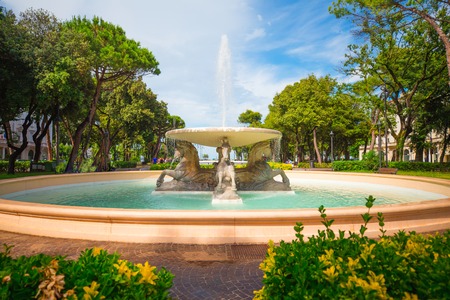 Central park of Rimini. Italy. Rimini city center with fountain and green trees.の写真素材