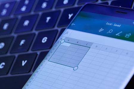 New york, USA - July 6, 2018: Microsoft excel menu on smartphone screen lay on laptop keyboardのeditorial素材