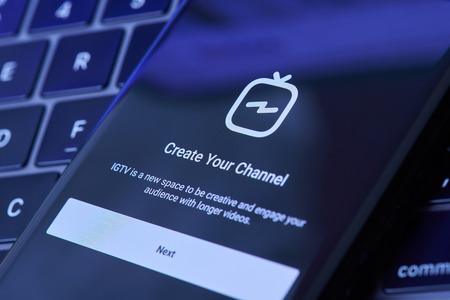 New york, USA - July 6, 2018:Create IGTV channel  in instagram menu on smartphone screen lay on laptop keyboardのeditorial素材