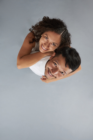 Young smiling couple isolated on gary background. Couple in loveの写真素材