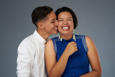 Kissing young couple on studio background. Happy people themeの写真素材