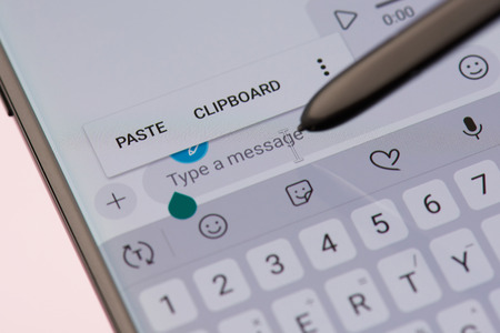 New york, USA - september 21, 2018: Texting in skype app on smartphone screen background close up viewのeditorial素材