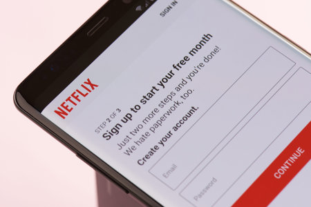 New york, USA - september 21, 2018: Sign up to netflix service on smartphone screen background close...
