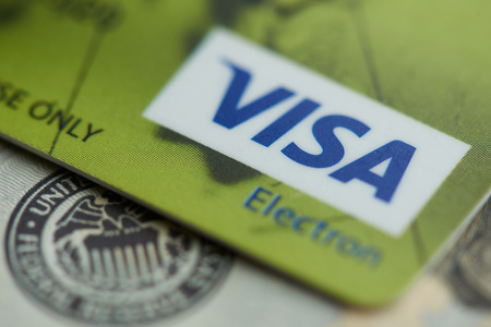 New york, USA - september 27, 2018: Visa electronic card close up view on dollar backgroundのeditorial素材