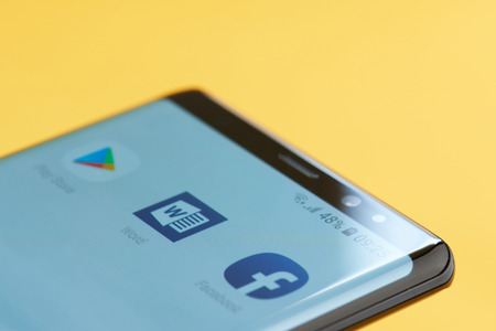 New york, USA - october 3, 2018: Microsoft word icon on smartphone screen close up view with yellow backgroundのeditorial素材