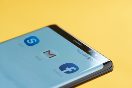 New york, USA - october 3, 2018: Gmail icon on smartphone screen close up view with yellow backgroundのeditorial素材