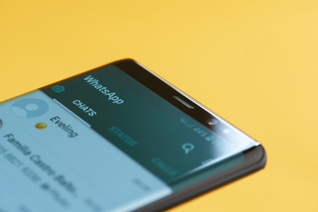 New york, USA - october 3, 2018: Whatsapp app on smartphone screen close up view with yellow backgroundのeditorial素材