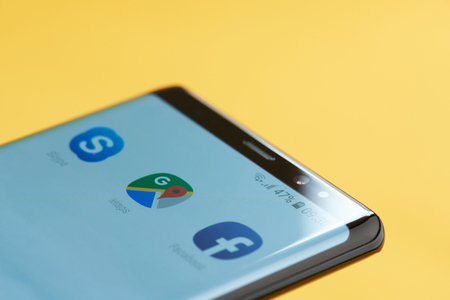New york, USA - october 3, 2018: Google maps icon on smartphone screen close up view with yellow backgroundのeditorial素材