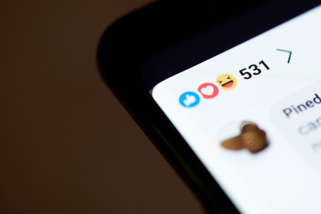 New york, USA - october 4, 2018: Reaction in facebook on smartphone screen close up viewのeditorial素材