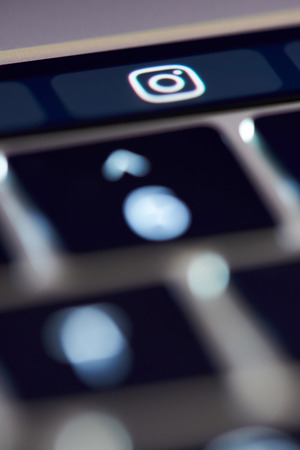 New york, USA - november 15, 2018: Instagram icon on touch bar  button close up viewのeditorial素材