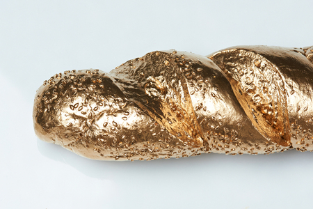 Close-up of golden baguette isolated on white backgroundの写真素材