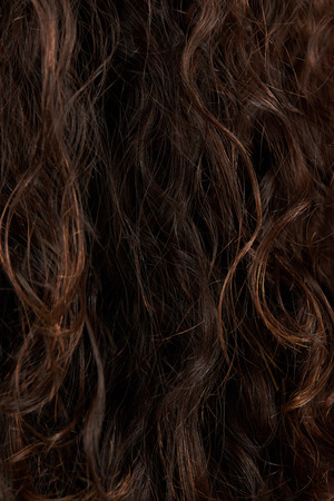 Latin woman curly hair texture. Dark color curly hairの写真素材