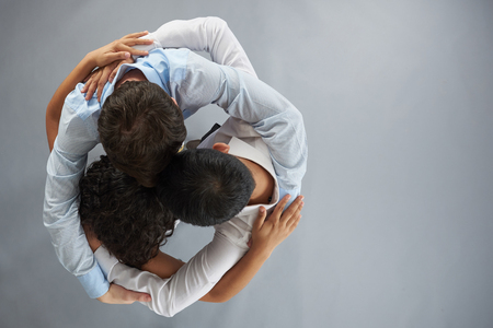 Unity group hug theme on gray studio background above top viewの写真素材