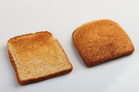 Two pieces of toasted bread isolated on white backgroundの写真素材