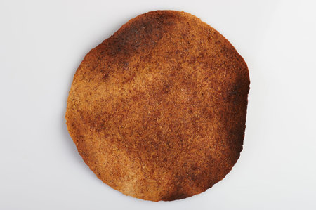 Brown burnt whole tortilla isolated on white background