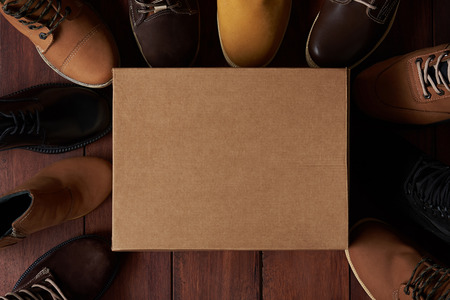 Cartoon clean shoe box with leather shoe toe on wooden backgroundの写真素材
