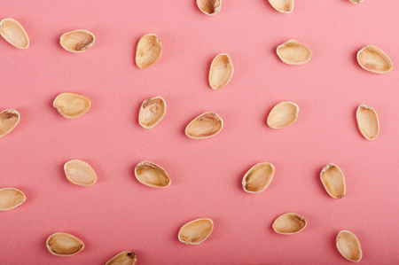Pattern of empty nut shells on pink backgroundの写真素材