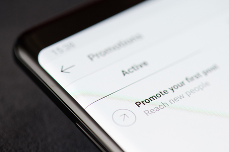 New york, USA - march 11, 2019: Promote post in instagram on smartphone screen close up viewのeditorial素材