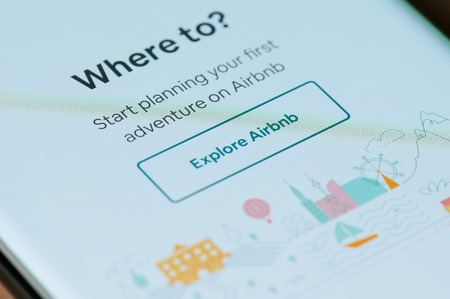 New york, USA - march 15, 2019: Explore airbnb application on smartphone screen close up viewのeditorial素材