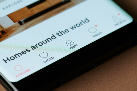 New york, USA - march 15, 2019: Airbnb menu app on smartphone screen close up viewのeditorial素材
