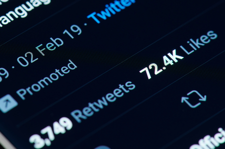 New york, USA - march 15, 2019: Likes and retweets in twitter post on smartphone screen close up viewのeditorial素材