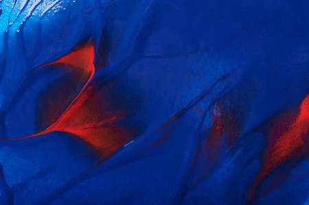 Abstract paint swirls blue and red color close up viewの写真素材