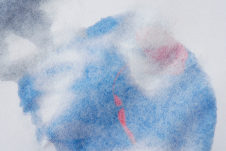 Blue water paint drop with red circle on back of paperの写真素材
