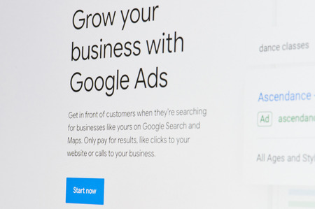 New york, USA - april 8, 2019: Grow business with google ads on digital screen macro close up viewのeditorial素材