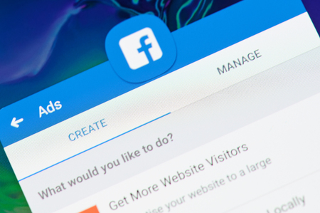 New york, USA - april 8, 2019: Create facebook ad on digital screen macro close up viewのeditorial素材
