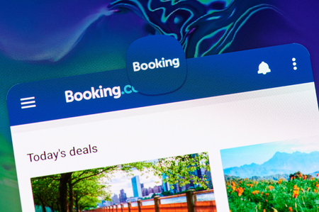 New york, USA - april 8, 2019: Booking hotel application on digital screen macro close up viewのeditorial素材