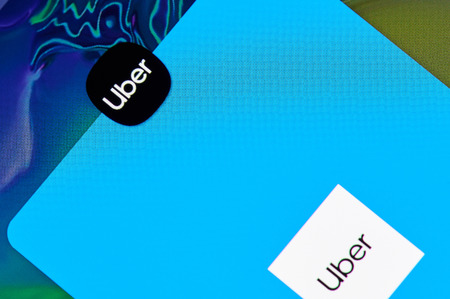 New york, USA - april 8, 2019: Uber taxi  application on digital screen macro close up viewのeditorial素材