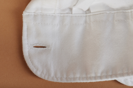 White shirt sleeve close up view on beige color backgroundの写真素材