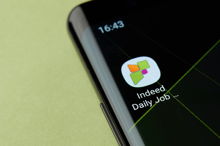 New york, USA - April 22, 2019: Indeed job search icon macro view on smartphone screen desktopのeditorial素材
