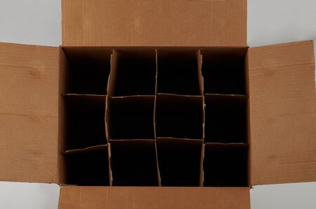 Open empty cardboard box for bottles with partitions above top viewの写真素材