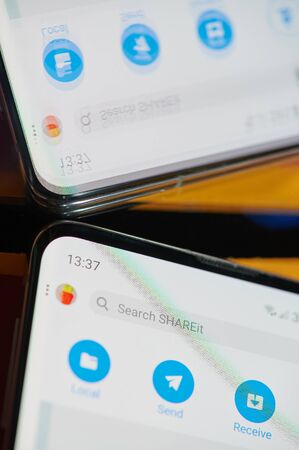 New york, USA - august 24, 2019: Using shareit application on smartphone  macro close up  mirror viewのeditorial素材