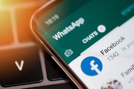 New york, USA - september 12, 2019: Whatsapp app chat with facebook in modern smartphone screen...